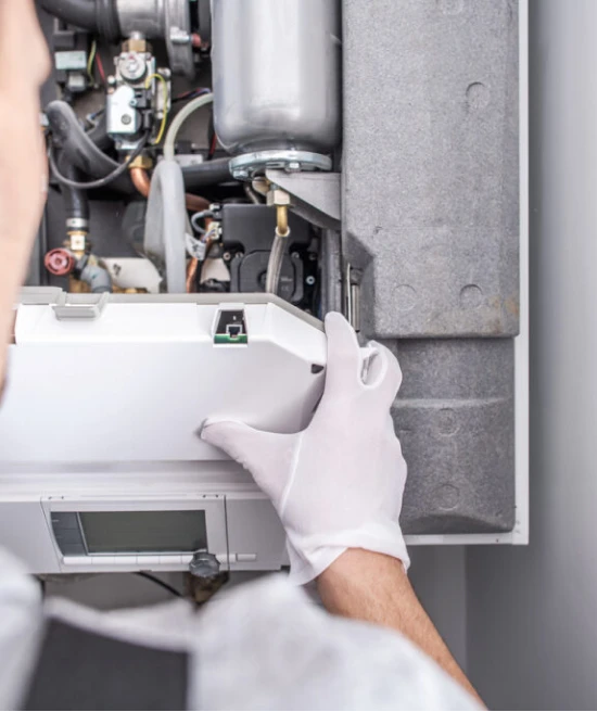 A man repairing heater indicating the expert heating repairing services in charlotte