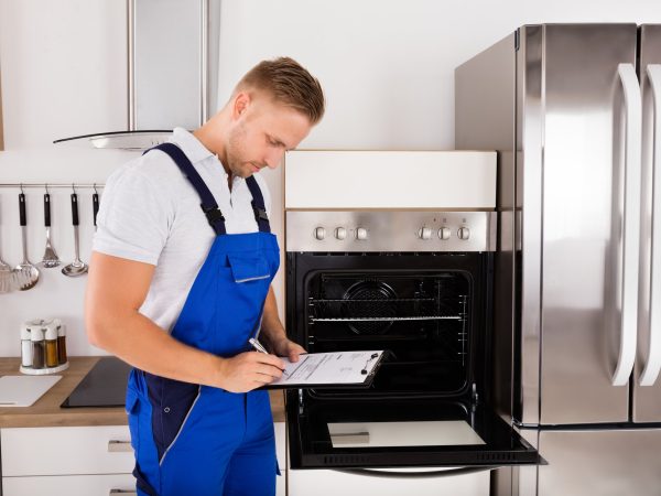 Clt appliances worker repairing stove oven