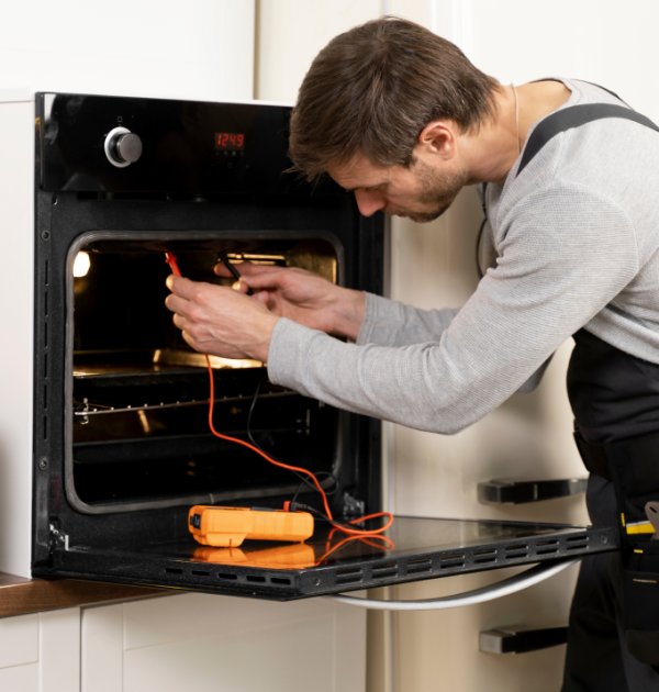 A man repairing oven