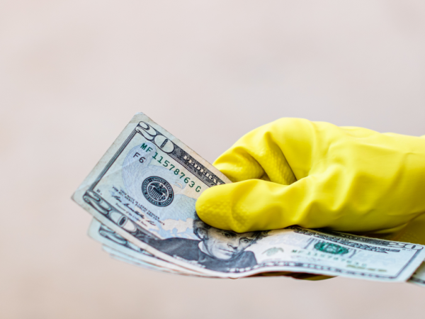 picture of hand, holding dollars.